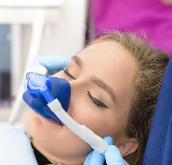 Patient receiving nitrous oxide sedation during dental procedure at Vegas Smile Suite.